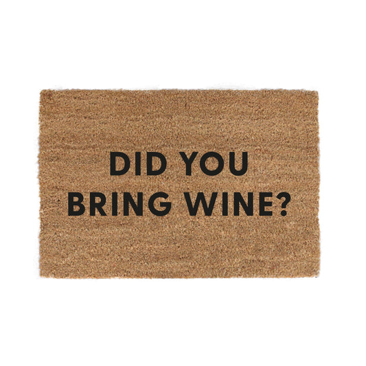 Kokosmåtter “Did you bring wine?” – humor og gæstfrihed ved døren